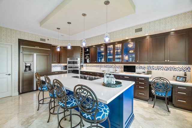 kitchen featuring a center island, black electric stovetop, double oven, and paneled fridge