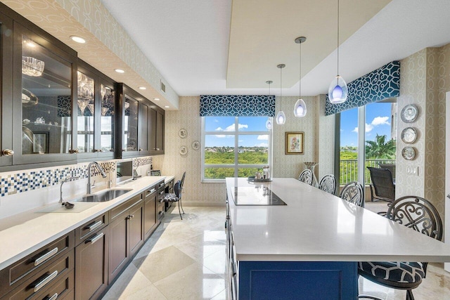 kitchen featuring a center island, decorative light fixtures, light tile patterned floors, and a kitchen bar