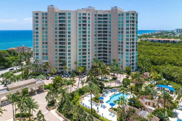 view of property featuring a community pool and a water view