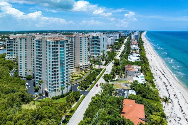 birds eye view of property featuring a beach view and a water view