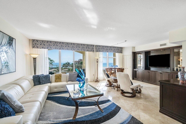 tiled living room with a textured ceiling