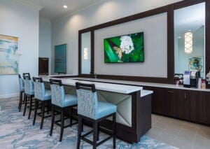 bar with light tile patterned floors and dark brown cabinetry