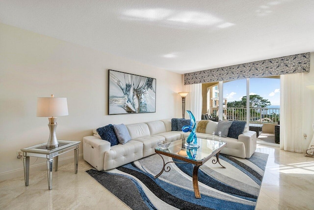 living room featuring a textured ceiling and light tile patterned floors