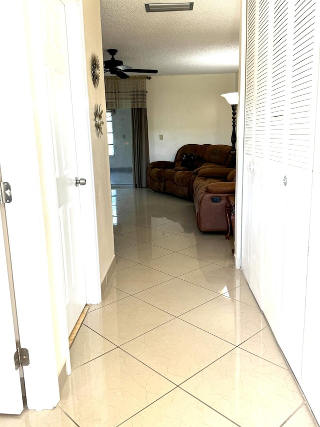 hallway with a textured ceiling