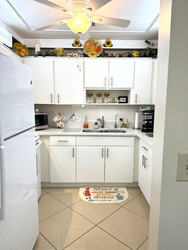 kitchen featuring light tile patterned floors, backsplash, white fridge, and sink