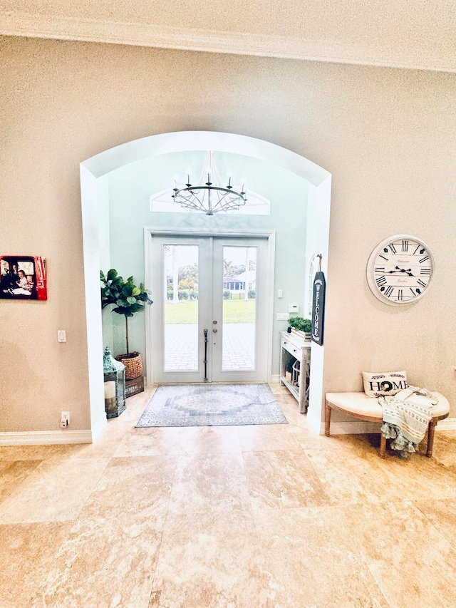 tiled entryway with french doors and a textured ceiling