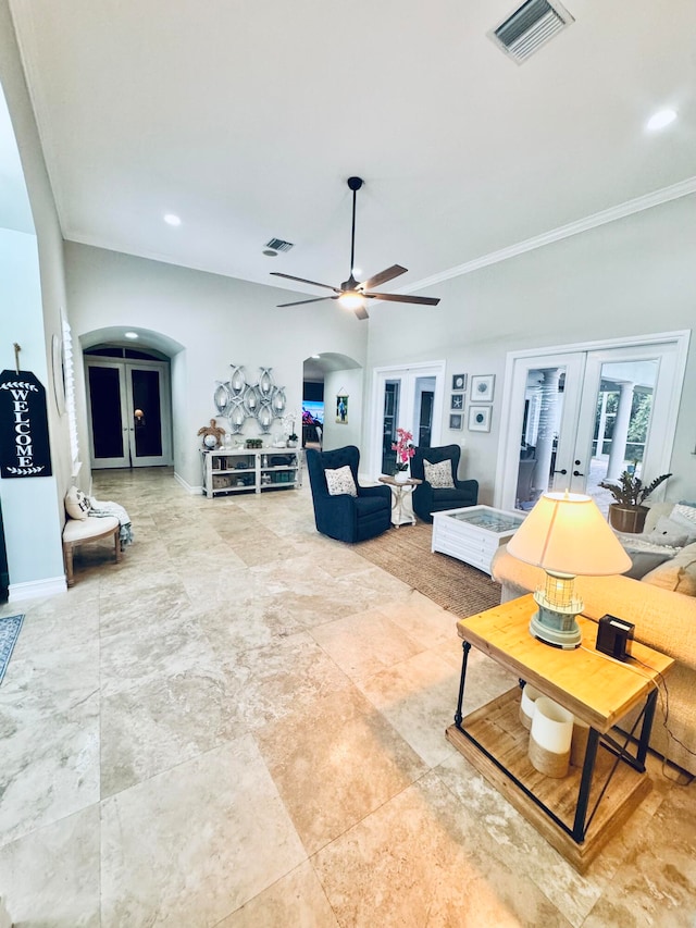 tiled living room featuring ceiling fan, french doors, and crown molding