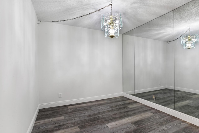 unfurnished dining area featuring wood finished floors, baseboards, and a textured ceiling