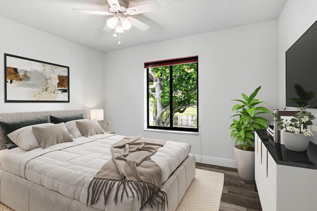 bedroom featuring dark wood-style floors, a textured ceiling, baseboards, and a ceiling fan