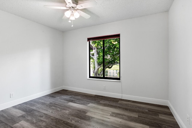 spare room featuring dark wood-type flooring, ceiling fan, and a textured ceiling