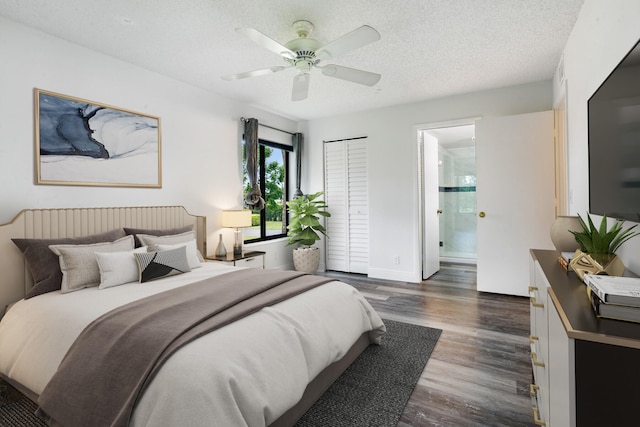 bedroom featuring a textured ceiling, dark hardwood / wood-style flooring, a closet, ensuite bath, and ceiling fan