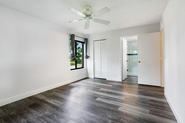 unfurnished bedroom featuring a textured ceiling, ceiling fan, dark hardwood / wood-style floors, and connected bathroom