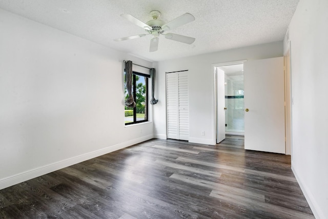 spare room with ceiling fan, wood finished floors, baseboards, and a textured ceiling