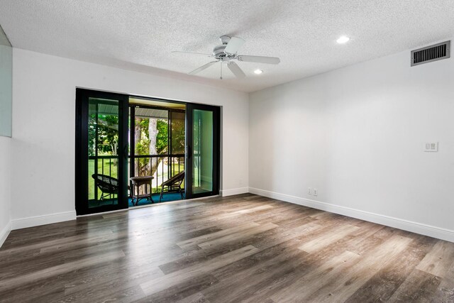 spare room with a textured ceiling, wood-type flooring, and ceiling fan