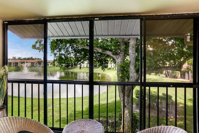 unfurnished sunroom with a water view