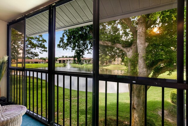 unfurnished sunroom featuring plenty of natural light and a water view