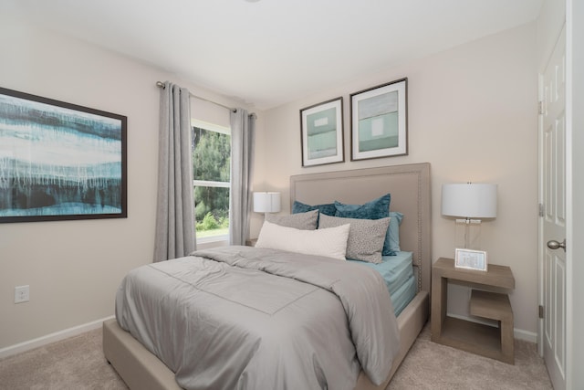 bedroom featuring light carpet