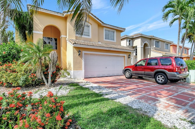 mediterranean / spanish home with a garage