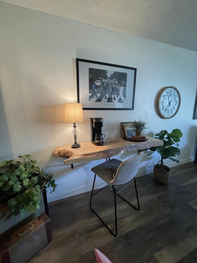 home office with a textured ceiling and dark hardwood / wood-style floors