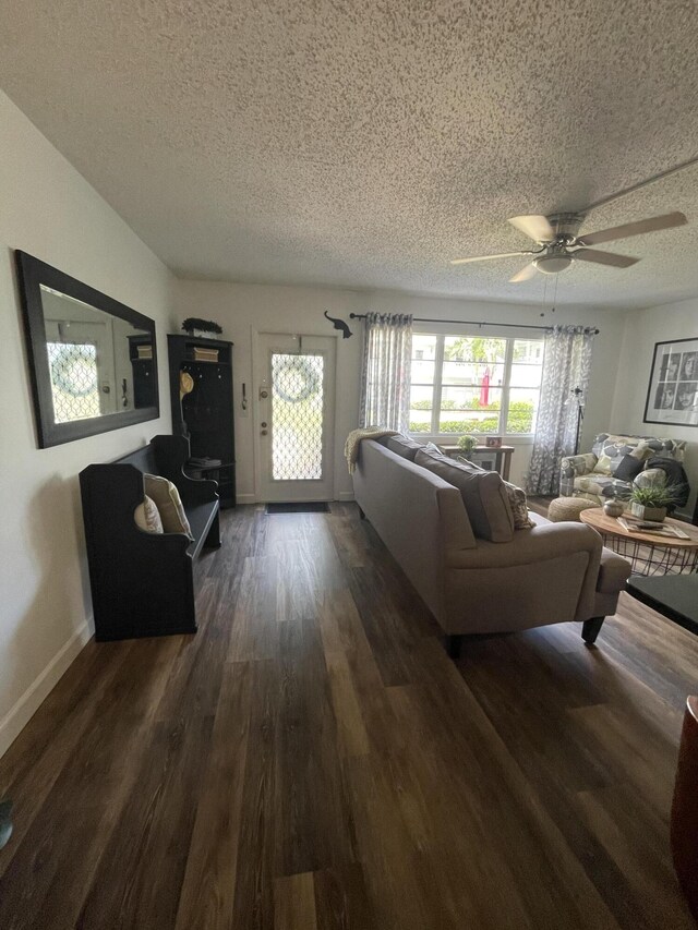 living room featuring hardwood / wood-style floors, a textured ceiling, and ceiling fan