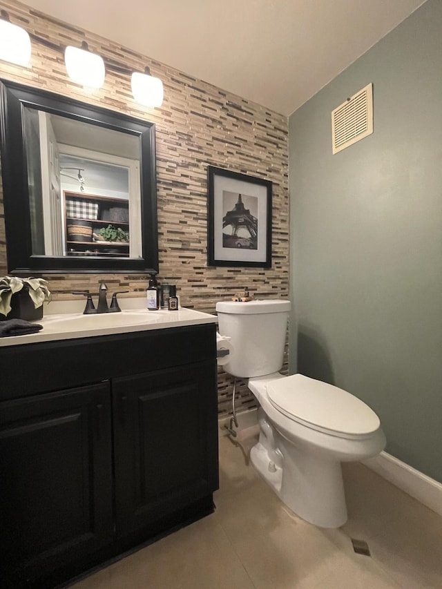 bathroom with tile walls, toilet, tile patterned floors, and vanity