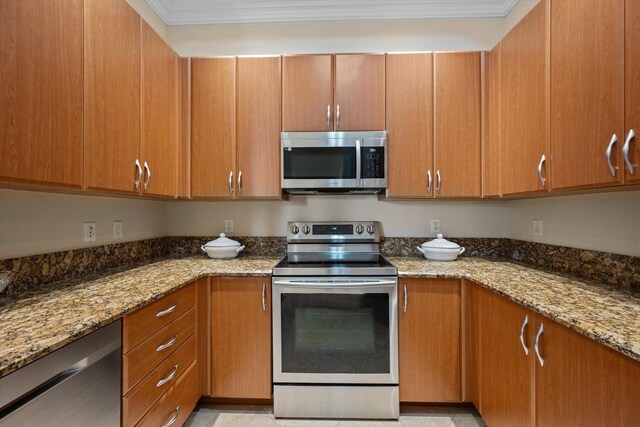 kitchen featuring stone countertops, crown molding, and stainless steel appliances