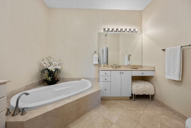 bathroom featuring a relaxing tiled tub, tile patterned floors, and vanity