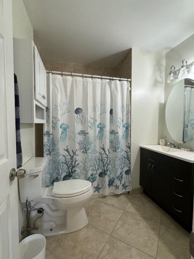 bathroom featuring tile patterned floors, toilet, vanity, and curtained shower