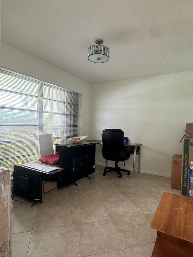 tiled home office featuring a textured ceiling