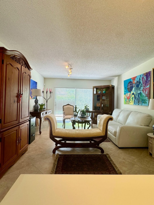 tiled living room featuring a textured ceiling