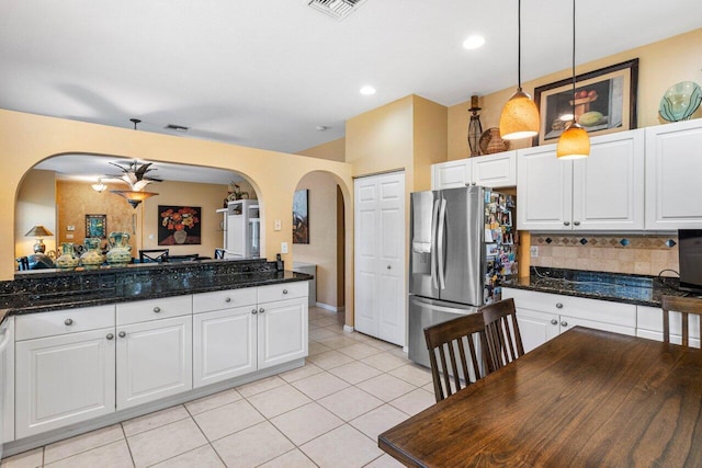 kitchen featuring white cabinetry and stainless steel refrigerator with ice dispenser