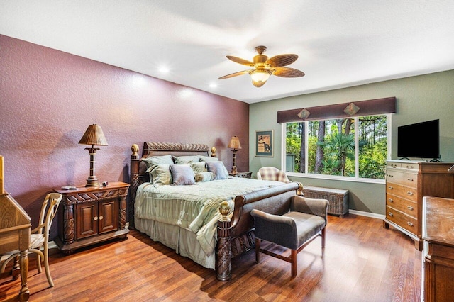 bedroom with ceiling fan and wood-type flooring