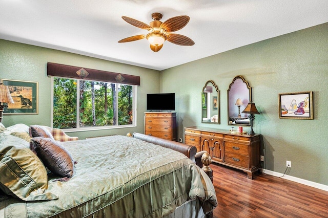 bedroom with dark wood-type flooring and ceiling fan