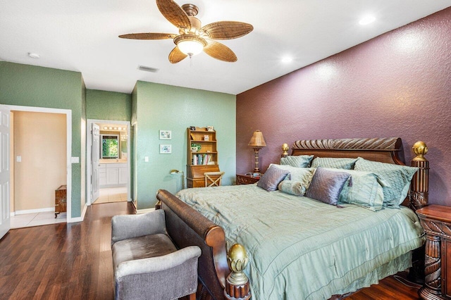 bedroom with connected bathroom, hardwood / wood-style floors, and ceiling fan