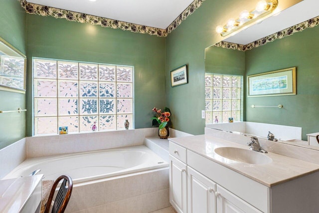 bathroom featuring vanity and a relaxing tiled tub