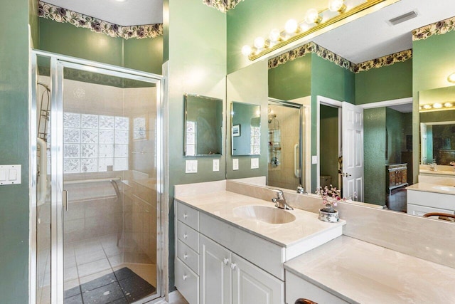 bathroom featuring vanity and a shower with door