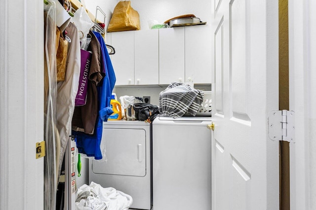 laundry room featuring cabinets and washer and dryer