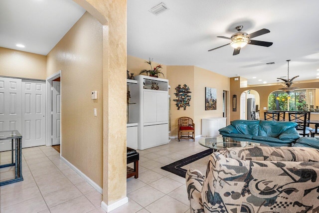 tiled living room featuring ceiling fan