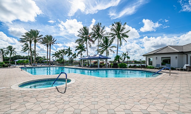 view of pool with a hot tub, a patio area, and a gazebo