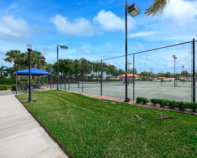 view of sport court featuring a yard and a gazebo