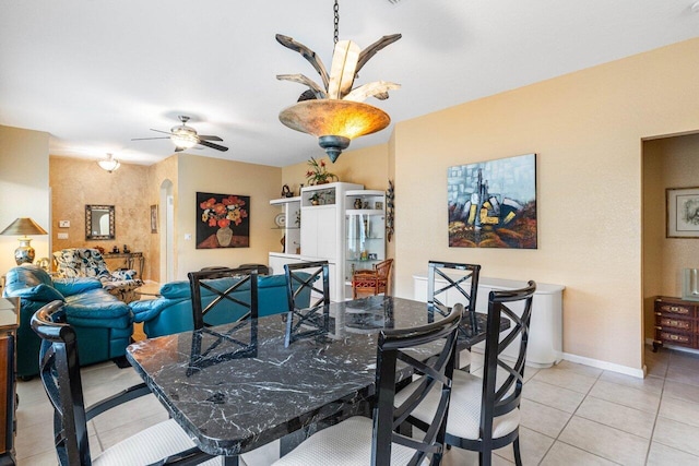 tiled dining room with ceiling fan