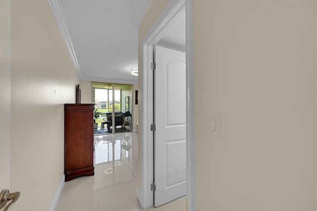 hall featuring crown molding and light tile patterned floors