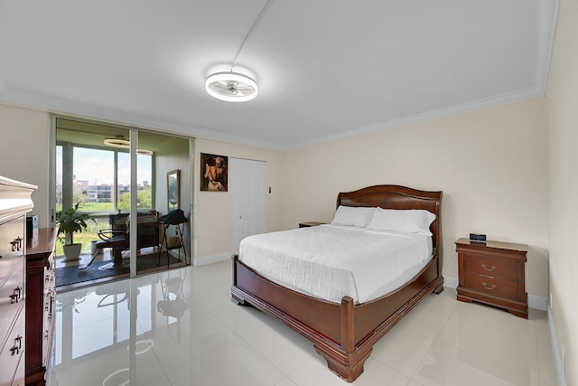 bedroom with light tile patterned flooring, ornamental molding, and a closet