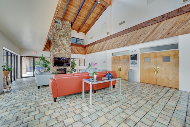 tiled living room with wooden ceiling, high vaulted ceiling, a stone fireplace, and beam ceiling