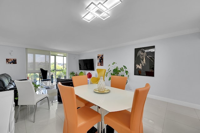 dining area with light tile patterned floors and crown molding