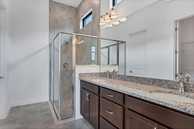 bathroom with vanity, tile patterned floors, and a shower with shower door