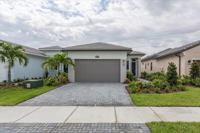 view of front facade with a front yard and a garage