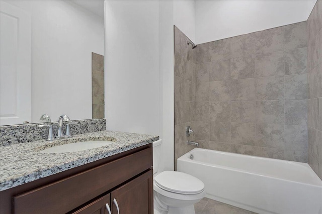 full bathroom with tile patterned flooring, tiled shower / bath combo, toilet, and vanity