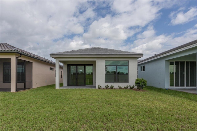 rear view of property with a lawn