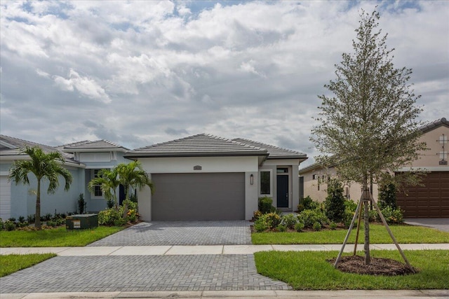 view of front of property featuring a garage and a front lawn